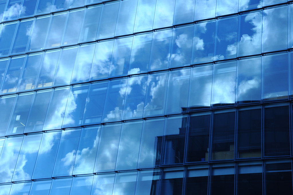 Cloud reflections across a commercial office window facade